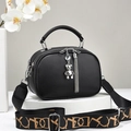 Black pebble leather crossbody handbag with wide patterned strap and metal bear charm - Black