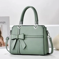 Elegant sage green handbag with bow detail and heart buckles for stylish commuting - Green