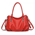 Red pebbled leather tote bag with round handles and adjustable shoulder strap on white base - Burgundy