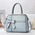 Light blue bow tote bag with heart metal accent and adjustable strap in textured faux leather - Light Blue