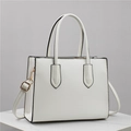 Elegant white crossbody tote bag in textured leather with golden hardware and shoulder strap - White