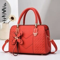 Elegant red litchi texture handbag with V-shaped stitching and floral charm accessory - Red