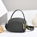 Detailed view of dark grey nylon crossbody bag with golden zippers and multi-layer design - Grey/Nylon