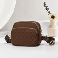 Deep brown quilted crossbody bag with multiple zippers and adjustable strap on white pedestal - Coffee/Quilted