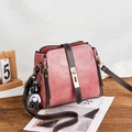 Dusty rose bucket bag with dark brown strap and cute bear charm on wooden table - Dusty Pink