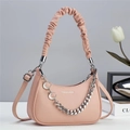 Detailed view of pink moon-shaped handbag featuring pebble leather and metal moon chain - L23 W6 H15 / Pink