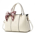 Beige faux leather handbag with geometric texture and decorative floral silk scarf - White