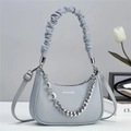Detail of grey half-moon bag featuring a scrunchie handle and moon pendant chain - L23 W6 H15 / Gray