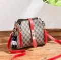 Brown monogram bucket bag with red leather strap and bear charm accessory - GD With Red