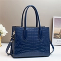 Elegant navy blue crocodile embossed tote bag with gold hardware and top handles - Blue