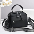 Sac à main noir texture lychee avec bandoulière à motif en V sur fond gris minimaliste - Noir