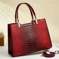Elegant burgundy crocodile pattern handbag with glossy finish and gold hardware details - Burgundy