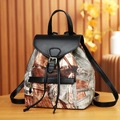Fashionable denim print backpack with leather trim and drawstring on wooden table - Black