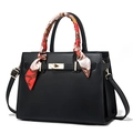 Klassische schwarze Lederhandtasche mit goldenem Drehverschluss und bedrucktem Seidentuch - Schwarz