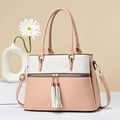 Elegant contrast color tote bag in soft leather with tassel details and long shoulder strap - Pink with White