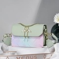 Pink and green crossbody bag with flamingo metal buckle and pearl detail on display - Green