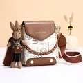 Chic white and brown crossbody bag with letter print, wide strap, and bunny pendant - Off White