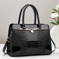 Elegant black crocodile-embossed handbag with glossy leather details and gold hardware - Black
