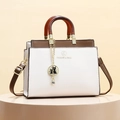 Contrast leather tote with amber handle and cat charm, white and brown luxury design - White