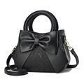 Elegant black snake-patterned crossbody bag featuring a large decorative bow and gold hardware - Sequin Black