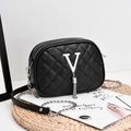 Minimalist black quilted crossbody bag with silver V-hardware, tassels and chain strap - Black