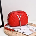 Red quilted three-layer crossbody bag with V-shaped metal logo and tassel detail - Red