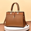 Brown woven leather handbag for women featuring gold hardware and adjustable strap - Earthy Yellow