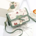 Crossbody square bag in green and cream featuring retro architectural city illustrations - Green