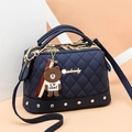 Navy blue quilted Boston bag with crossbody strap and a cute brown bear charm - Dark Blue