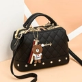 Black quilted Boston bag with gold hardware and a cute brown bear cartoon pendant - Black