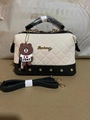 Beige quilted Boston bag with black base, golden studs, and brown bear charm accessory - Off-white