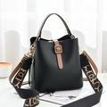 Chic black leather bucket bag with wide jacquard strap and minimalist metal hardware - Black