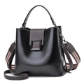 Women's black bucket bag with brown contrast handle and striped woven shoulder strap - Black