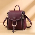 Close-up of burgundy PU leather bag with golden D-ring buckle and contrast stitching - Burgundy