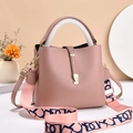 Pink lychee grain leather bucket bag with wide patterned strap and gold hardware - Pink