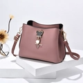 Dusty rose bucket bag with a crystal-studded Mickey charm on a display stand - Dusty Pink