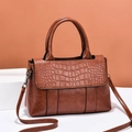Brown women's handbag with crocodile pattern flap and adjustable crossbody strap - Caramel color