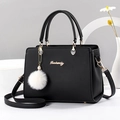 Classic black leather handbag for women with gold logo and white faux fur keychain - Black