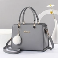 Elegant grey leather tote bag for women with gold hardware and plush charm - Dark Gray