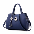 Minimalist dark blue top-handle bag with lychee texture and metallic tassel detail - Dark Blue