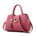 Minimalist lotus pink handbag for women featuring litchi texture and elegant tassel detail - Deep Pink