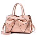 Glossy lotus pink crocodile embossed tote bag with a large decorative bow and top handle - Pink