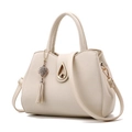 Beige faux leather handbag with tassel charm and gold droplet buckle in medium size - Beige