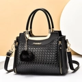 Classic black woven textured PU leather handbag with gold logo and pompom charm detail - Black