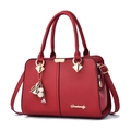 Elegant red lychee pattern handbag with gold hardware and decorative tassel for women - Burgundy