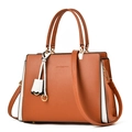 Brown and white bicolor tote bag with gold hardware and adjustable strap in a structured design - Earthy Yellow