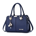 Dark blue pebbled leather handbag with gold hardware and pearl floral bag charm - Dark Blue