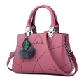 Pink quilted crossbody handbag with litchi texture and fur pompom charm on white background - Single Bag / Pink