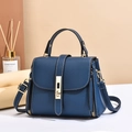Navy blue lychee leather handbag with gold twist lock and white stitching in 45-degree view - Blue