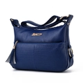 Blue faux leather handbag with crocodile texture and tassel decoration on white background - Royal Blue